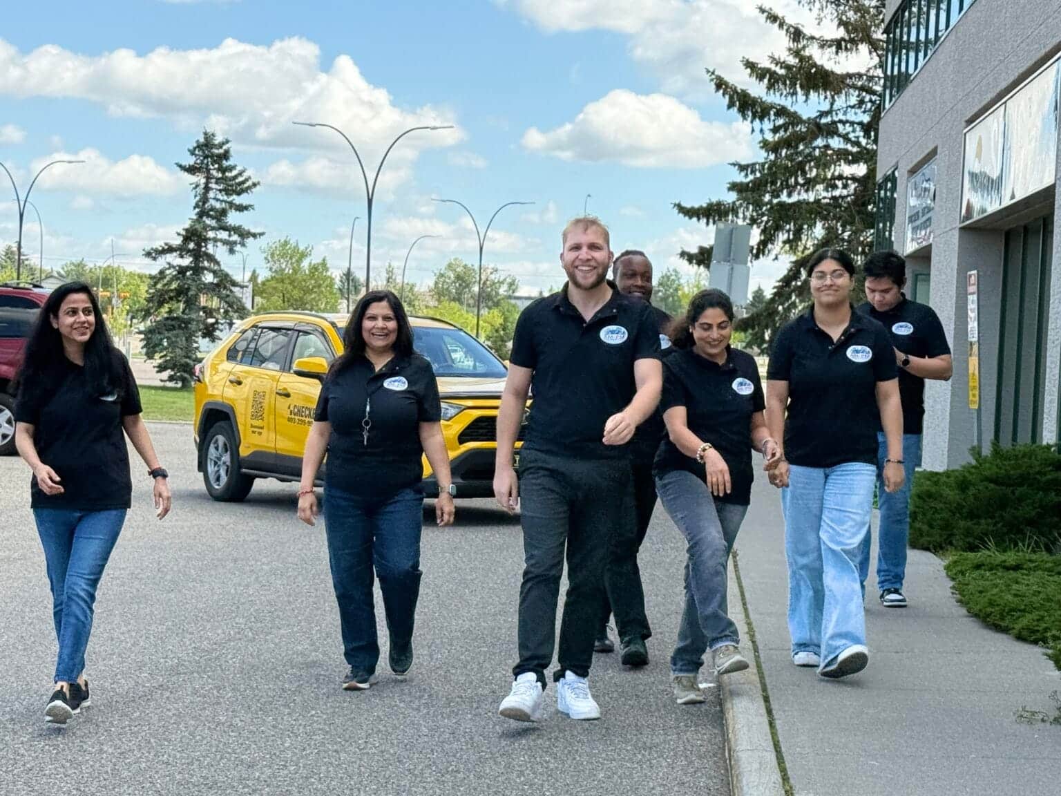 The AM PM Properties team walking together outside the office