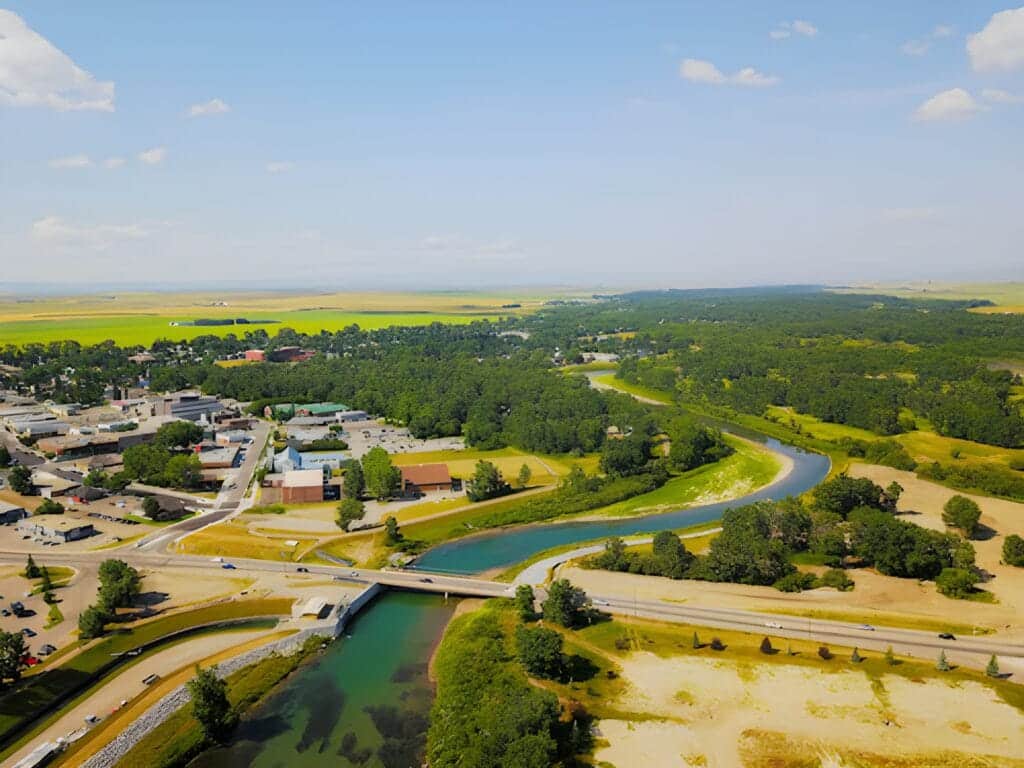 Aerial view of High River, Alberta, with the Highwood River, downtown and open farmland beyond