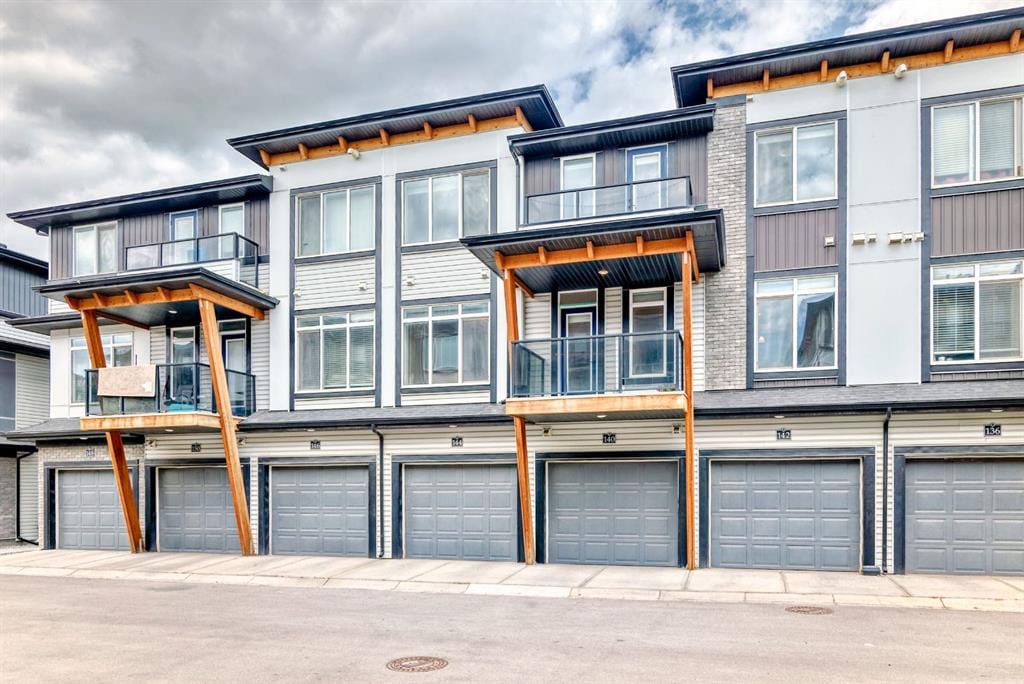A row of modern three storey townhouses with front garages