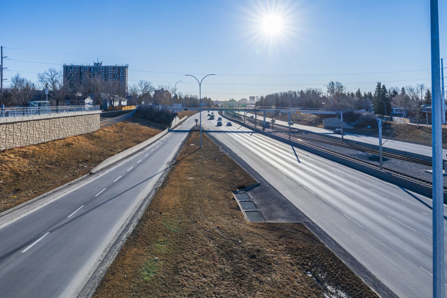 An open Calgary roadway heading toward the city on a clear day