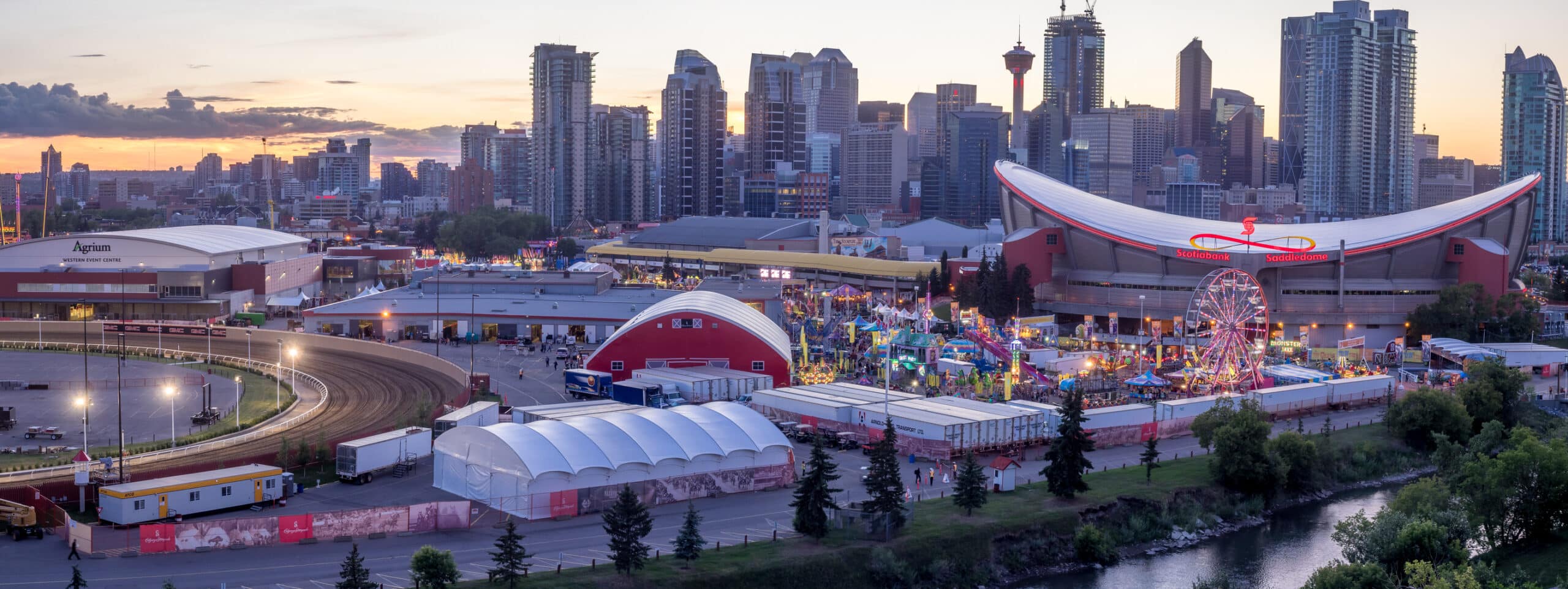 Calgary downtown skyline at dusk seen from the east with the Saddledome and the Stampede grounds in the foreground