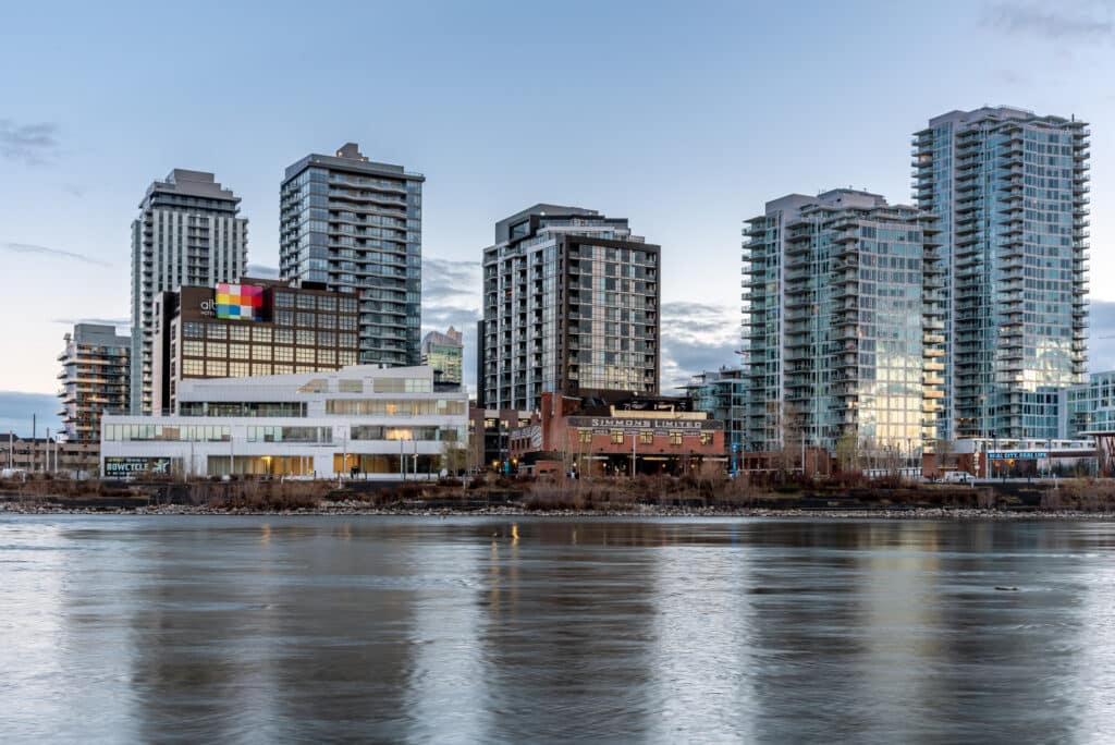 Modern riverside apartment buildings in Calgary on a bright day