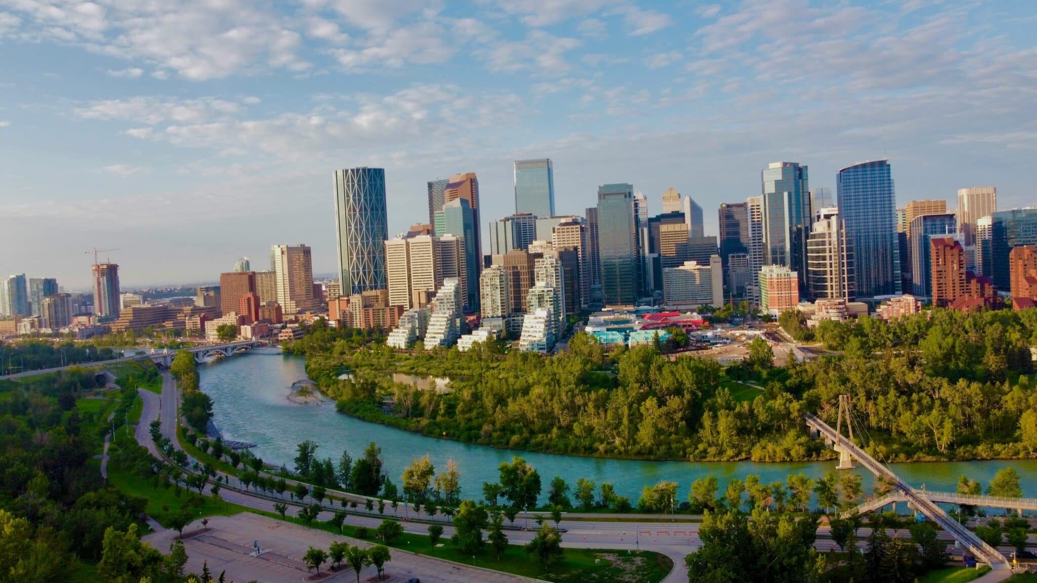 Downtown Calgary skyline above the Bow River and its pathways on a summer morning