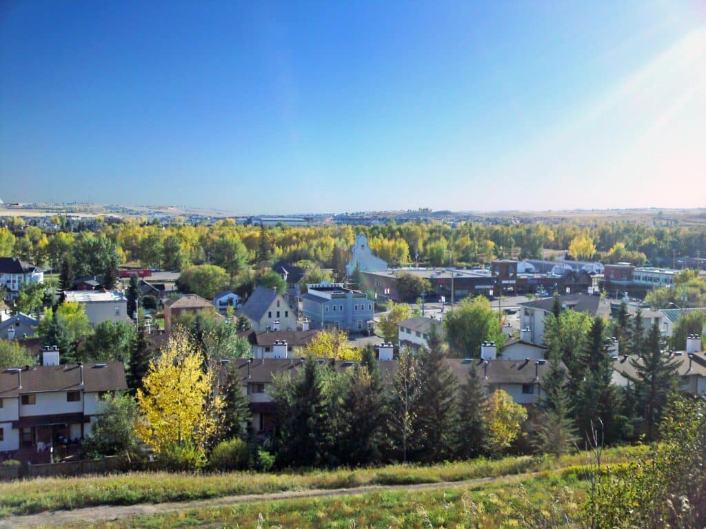Okotoks, Alberta in autumn, homes and the old town centre among golden trees
